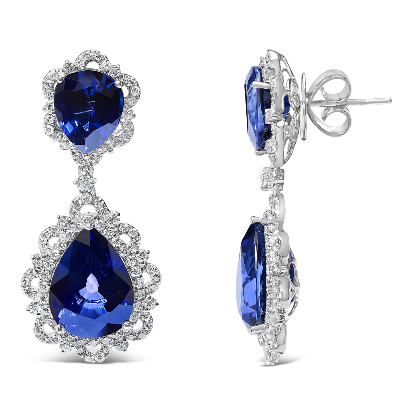 Front and side view of white metal drop earrings with two pear-shaped blue gemstones surrounded by small white gemstones in a decorative setting.