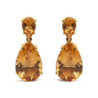 Front view of yellow metal earrings with pear-shaped orange gemstones in a two-tiered design.