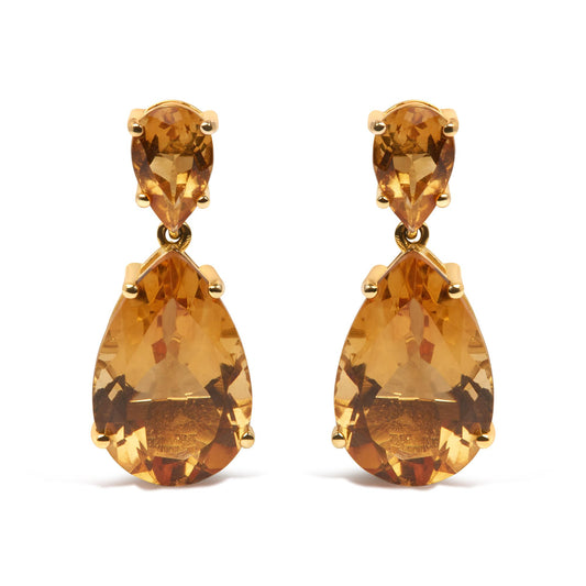 Front view of yellow metal earrings with pear-shaped orange gemstones in a two-tiered design.