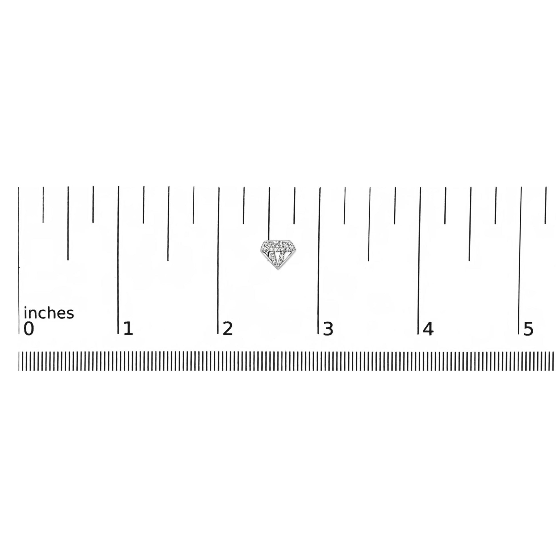 Close-up front angle of a small white metal earring shaped like a diamond with multiple white round gemstones in prong settings, shown on a ruler scale.