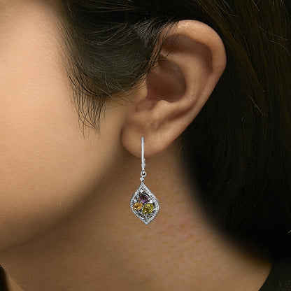 Earring shown worn on a model, white metal drop design with a marquise-shaped outline paved with small white gemstones, featuring a cluster of pear-shaped purple, green, oval yellow, and marquise blue gemstones in prong settings in the center, photographed from a side angle.