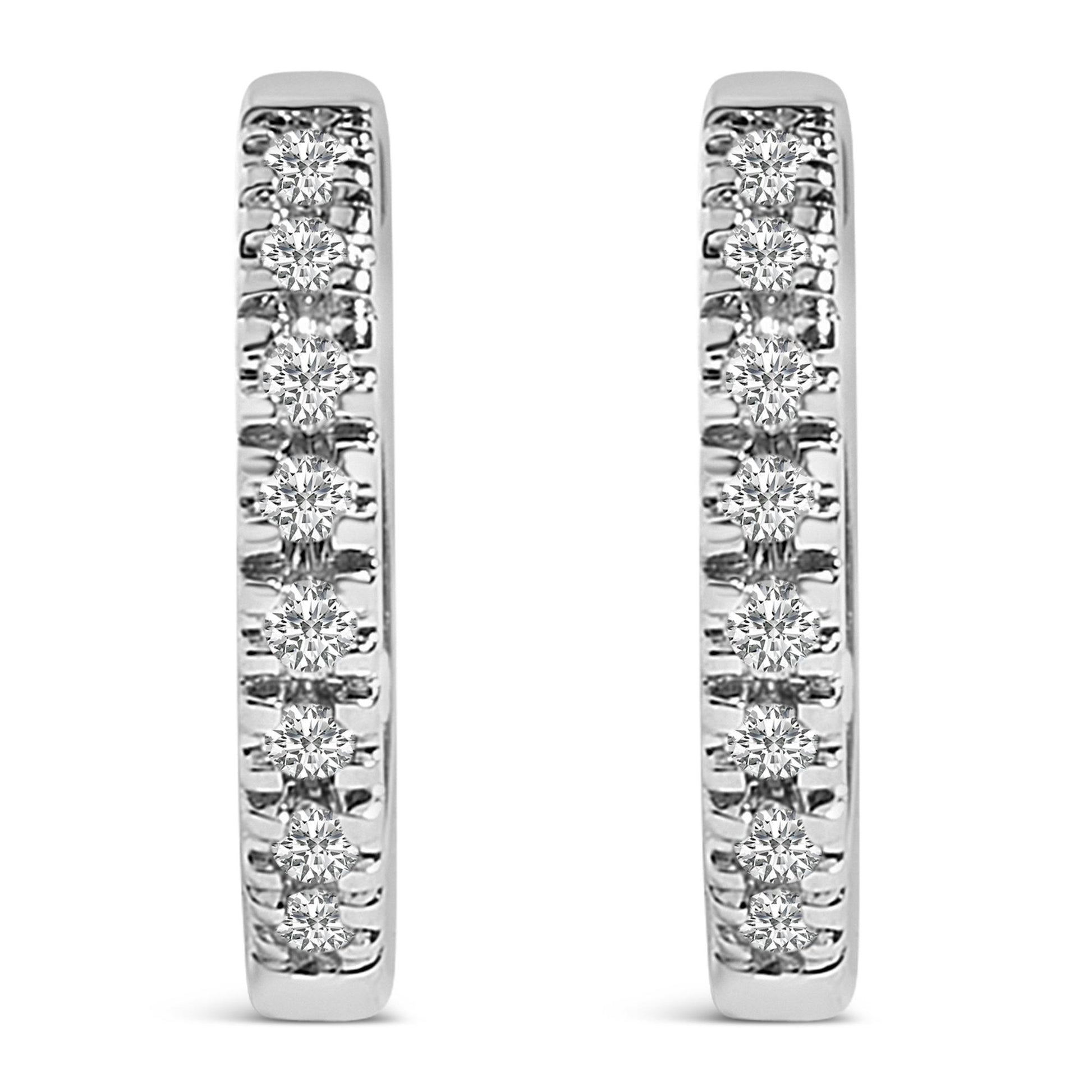 Close-up front view of a pair of white metal hoop earrings, each set with multiple round white gemstones in a 4-prong setting.