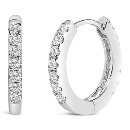 Pair of white metal hoop earrings with round white gemstones set in a shared prong setting, shown from the front and angled side close-up.