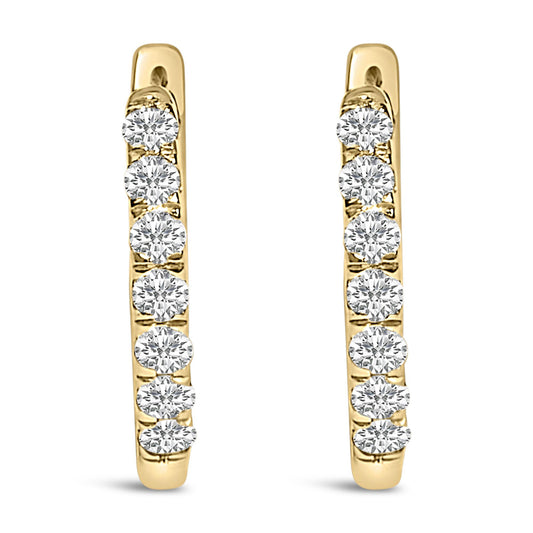 Pair of yellow metal hoop earrings with a row of round white gemstones in shared prong setting, shown from a front angle on a white background.