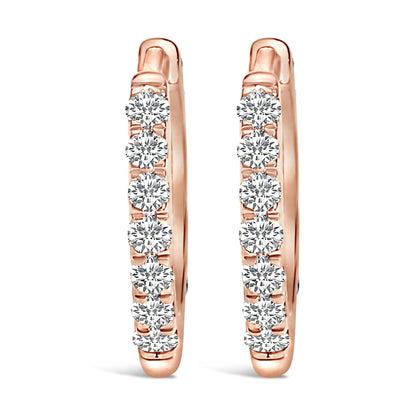 Pair of rose-colored hoop earrings with round white gemstones in shared prong settings, front-facing angle.