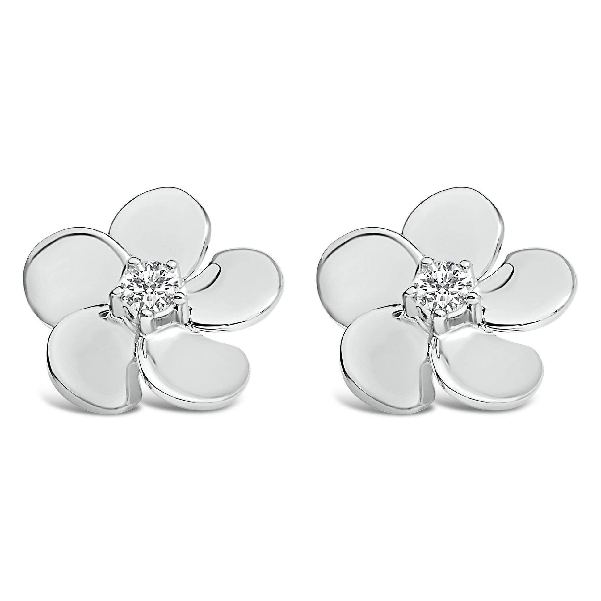 Pair of white metal flower-shaped earrings with round white gemstones in prong settings at the center, shown from a front angle on a white background.