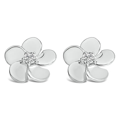 Pair of white metal flower-shaped earrings with round white gemstones in prong settings at the center, shown from a front angle on a white background.