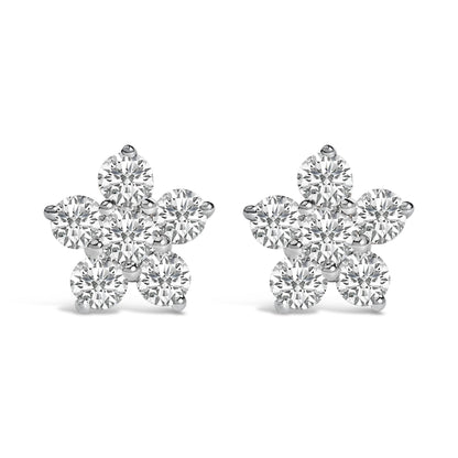 Pair of white metal flower-shaped earrings with round white gemstones in prong settings, shown from the front on a white background.
