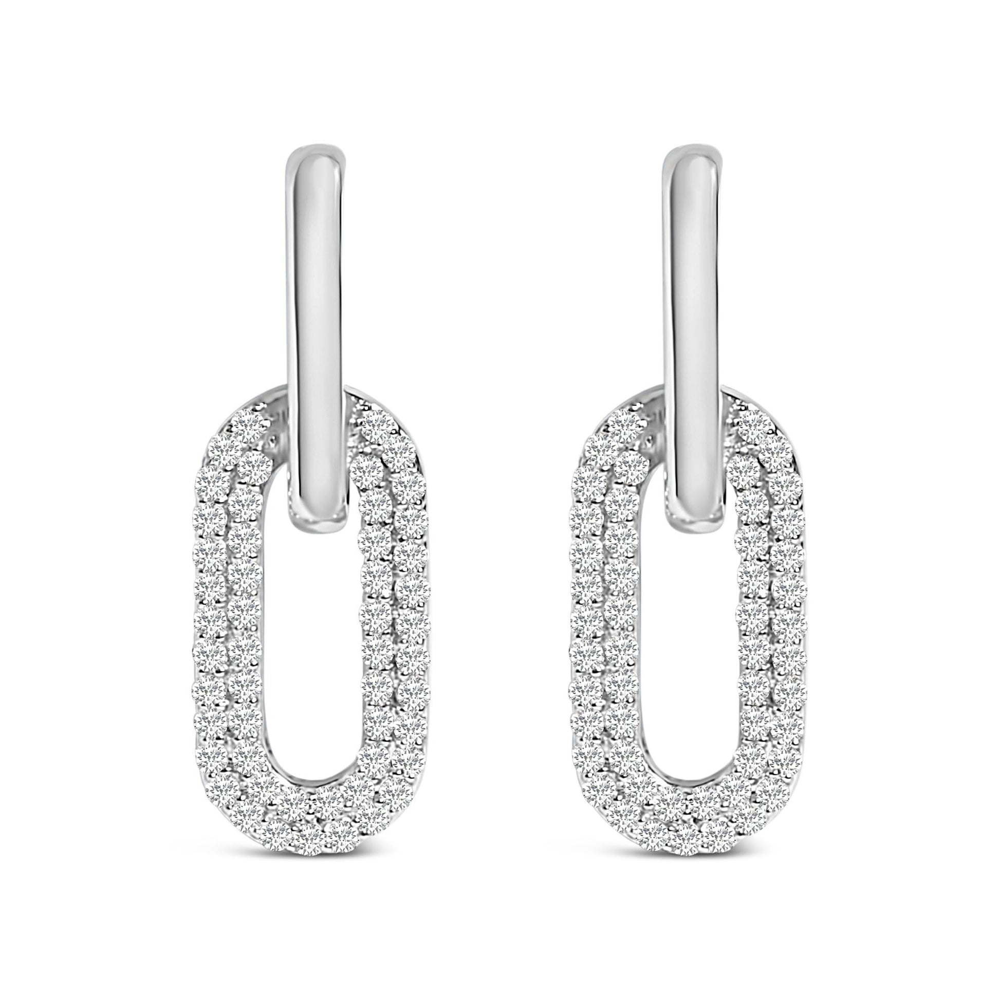 Front view of white metal earrings with oval-shaped loops encrusted with multiple round white gemstones in a shared prong setting.