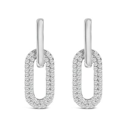 Front view of white metal earrings with oval-shaped loops encrusted with multiple round white gemstones in a shared prong setting.