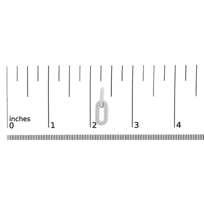 Close-up front view of a white metal earring with an elongated oval lower loop encrusted with small white gemstones in a shared prong setting, shown on a scale.