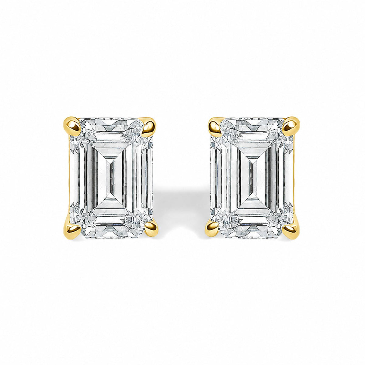 Close-up front view of yellow metal stud earrings featuring rectangular white gemstones in four-prong settings, shown on a white background.