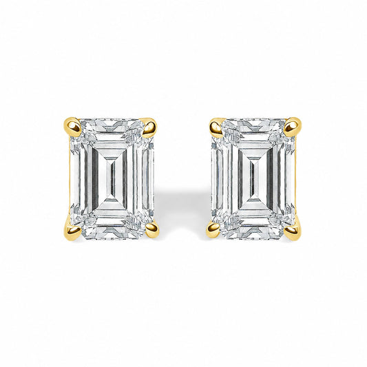 Close-up front view of yellow metal stud earrings featuring rectangular white gemstones in four-prong settings, shown on a white background.