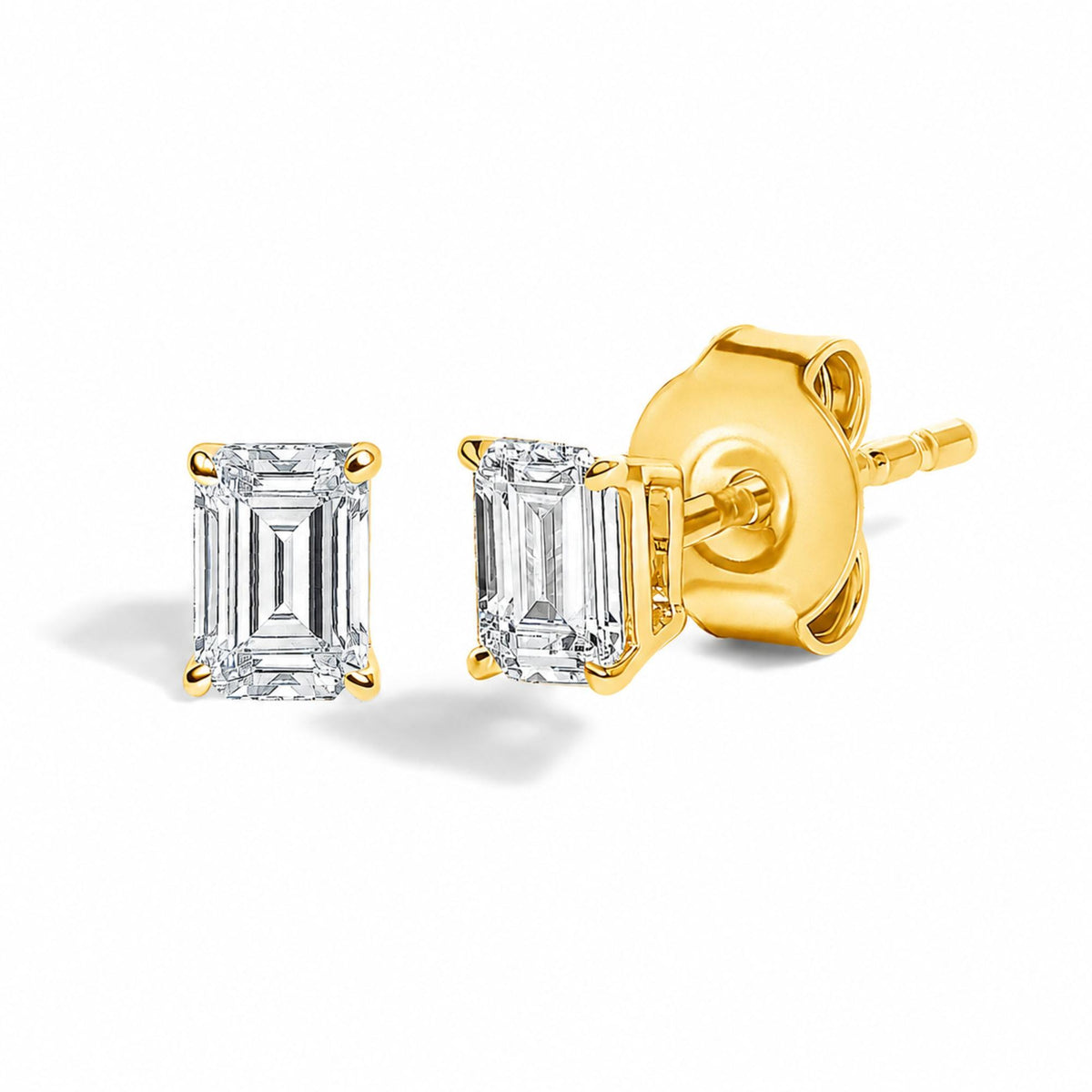 Close-up front and side view of yellow metal stud earrings with rectangular white gemstones in a four-prong setting.