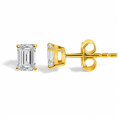 Close-up shot of yellow metal stud earrings featuring white emerald-shaped gemstones in a four-prong setting, shown from the front and side on a white background.
