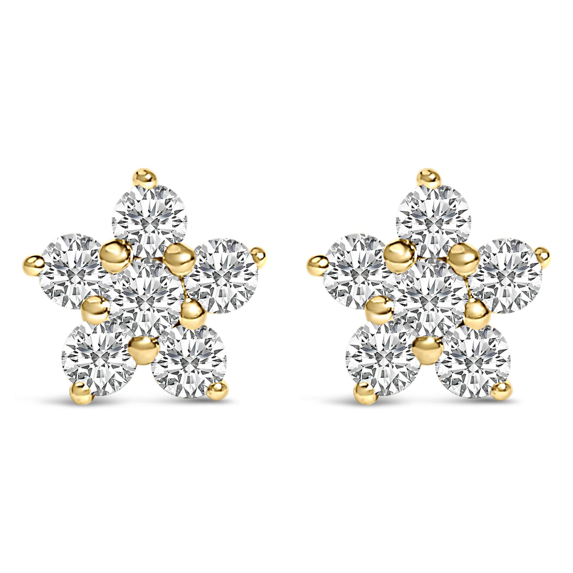 Pair of yellow metal earrings designed as star shapes with round white gemstones in prong settings, shown from the front angle on a white background.
