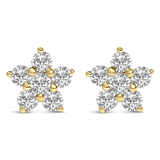 Pair of yellow metal earrings designed as star shapes with round white gemstones in prong settings, shown from the front angle on a white background.