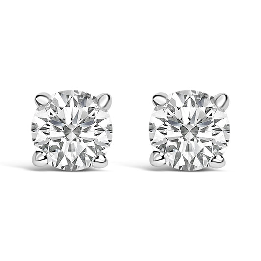 Close-up front view of a pair of white metal stud earrings, each featuring a round white gemstone in a four-prong setting.