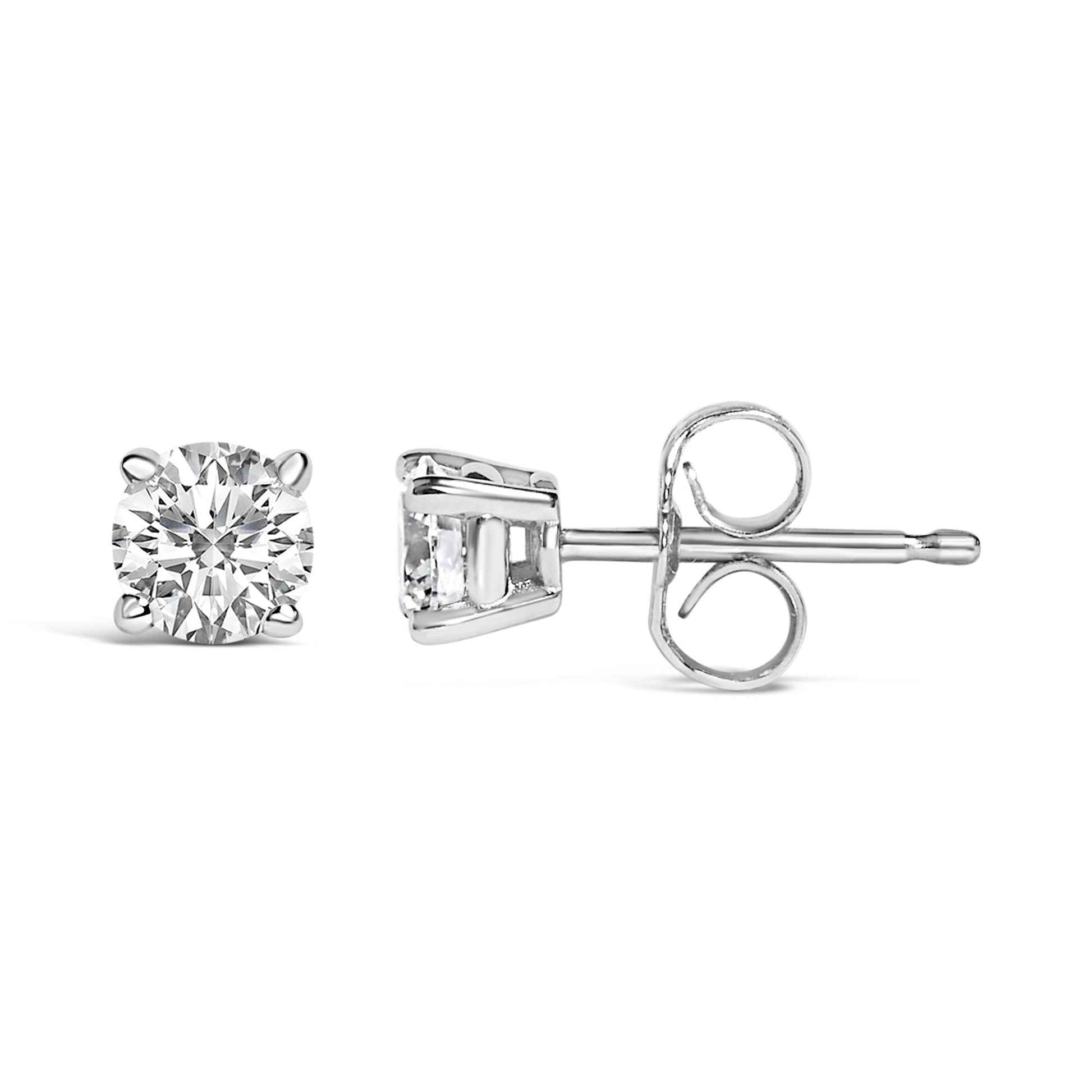 Close-up front and side views of a single white metal stud earring with a round white gemstone in a 4-prong setting.