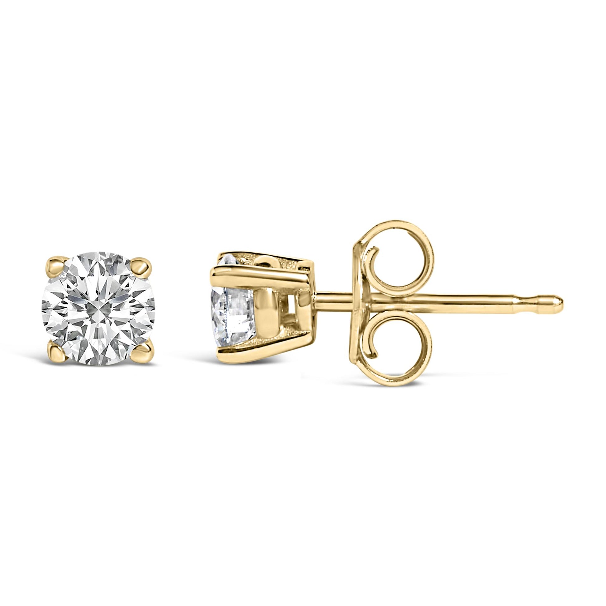 Pair of yellow metal stud earrings with round white gemstones in 4-prong settings, shown from front and side angles on a white background.