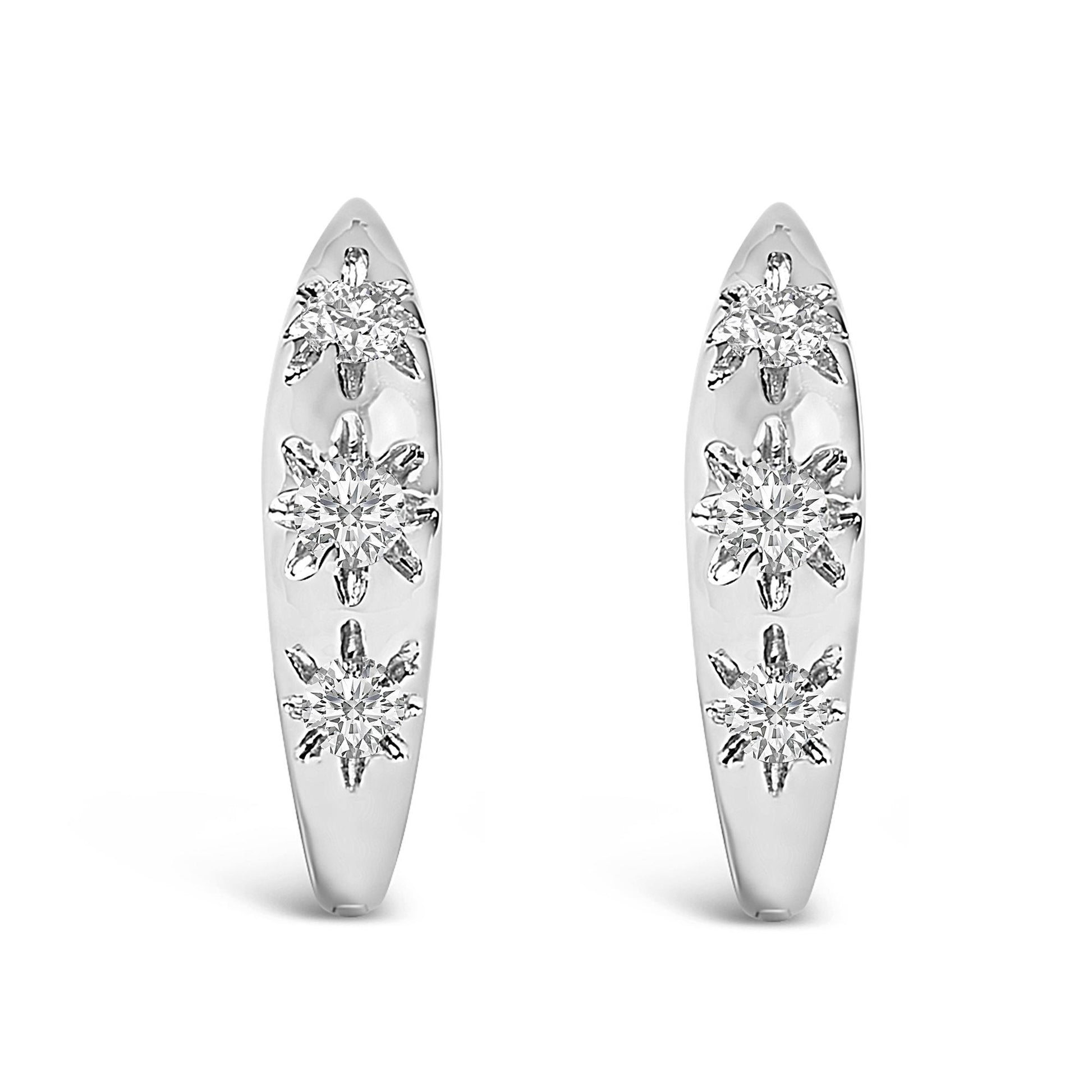 Pair of white hoop earrings with three round white gemstones in prong settings on each, shown in a front-facing angle on a white background.