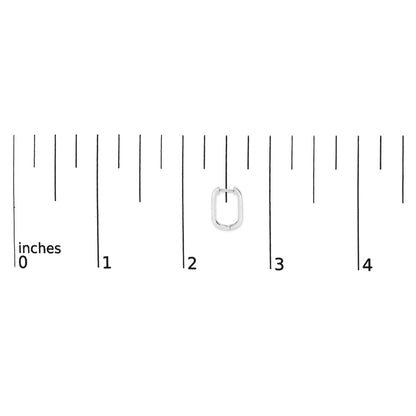 Close-up front view of a single white metal earring with round white gemstones in bezel settings, displayed on a ruler scale.