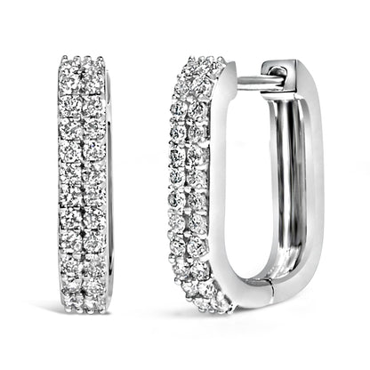 Close-up front and side views of white metal rectangular hoop earrings set with multiple rows of round white gemstones in shared prong settings.