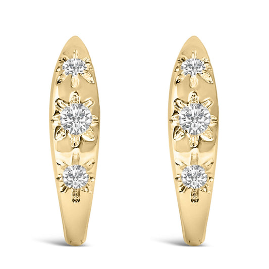 Pair of yellow metal earrings shown from front angle, each with three round white gemstones in prong settings arranged vertically with floral designs.