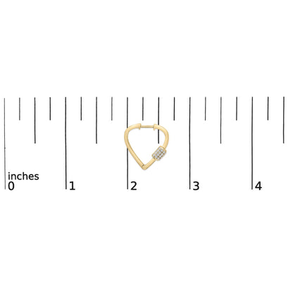 Yellow metal earring with a triangular shape and a cluster of small white gemstones on one side, shown on a scale from a top front angle.