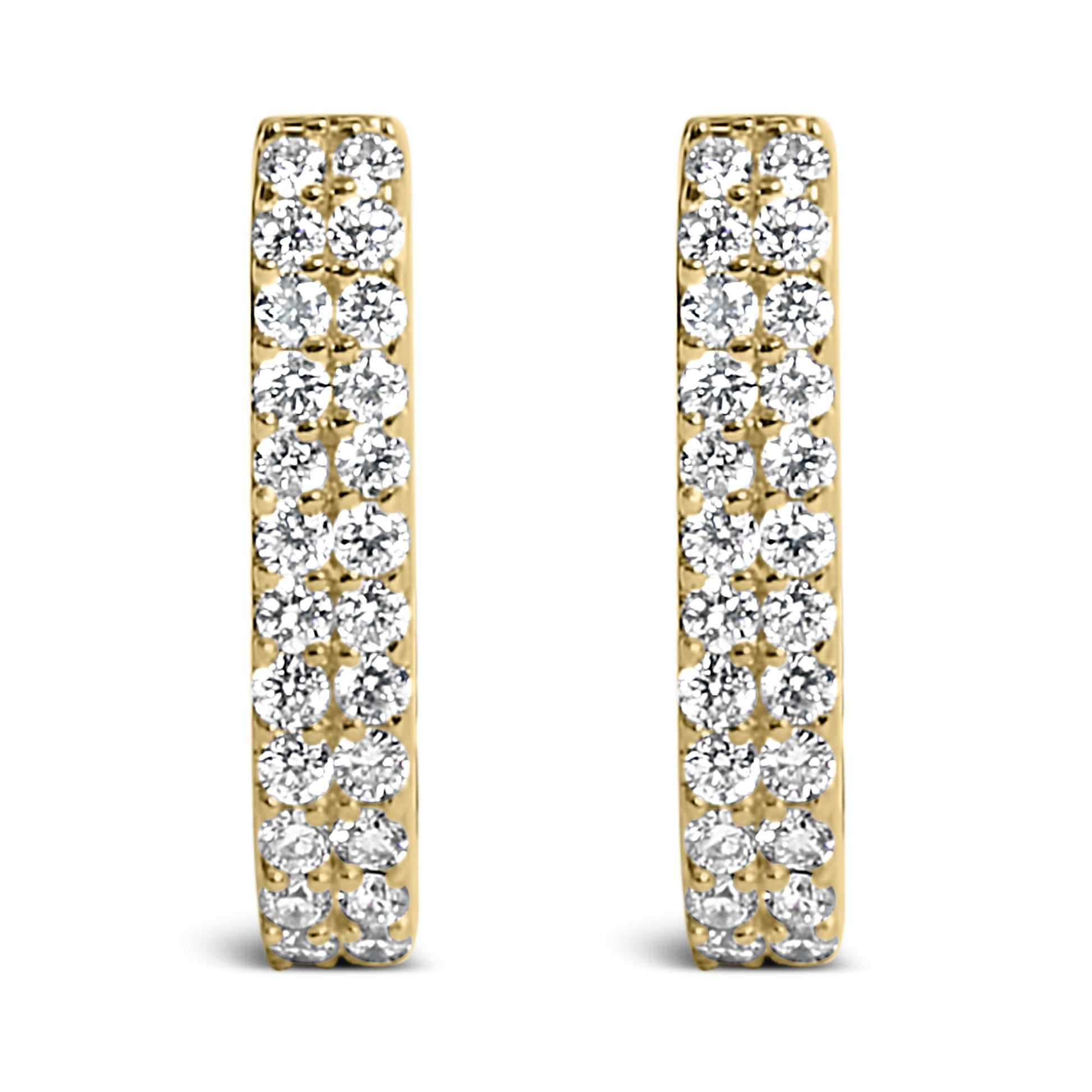 Front view of a pair of yellow metal earrings, each set with multiple white round gemstones in shared prong settings.