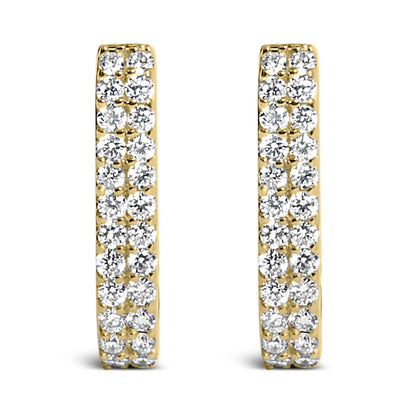 Front view of a pair of yellow metal earrings, each set with multiple white round gemstones in shared prong settings.