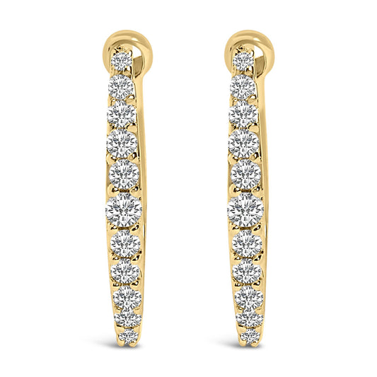 Front-facing close-up of a pair of yellow metal hoop earrings each set with a row of white round gemstones in a shared prong setting.