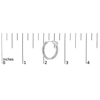 White metal hoop earring with round white gemstones in shared prong setting, shown on a scale, top-down angle.