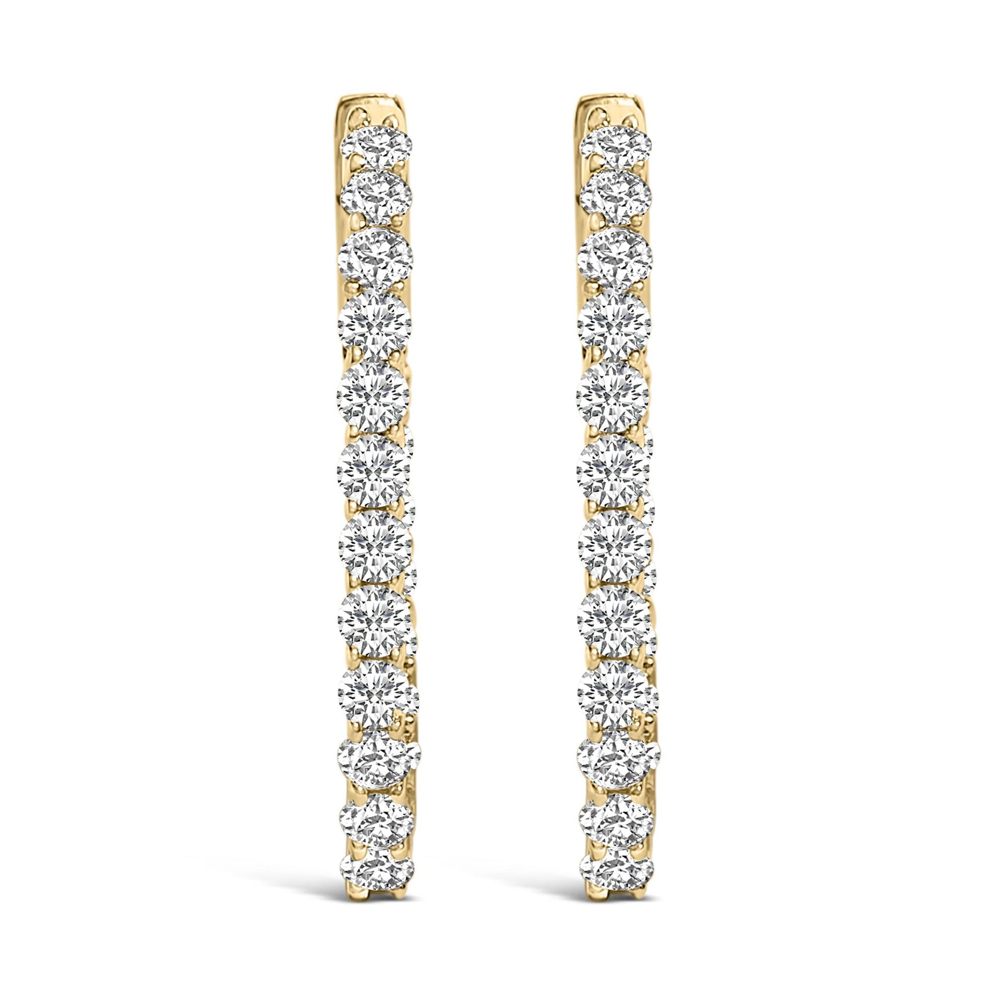 Front view of a pair of yellow metal hoop earrings, each adorned with a vertical line of round white gemstones in a shared prong setting.