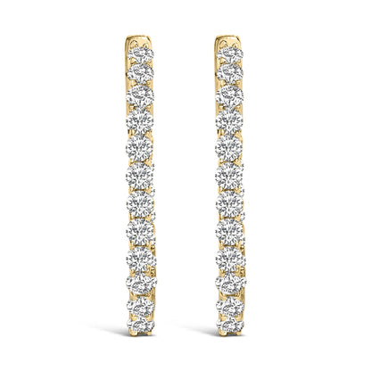 Front view of a pair of yellow metal hoop earrings, each adorned with a vertical line of round white gemstones in a shared prong setting.