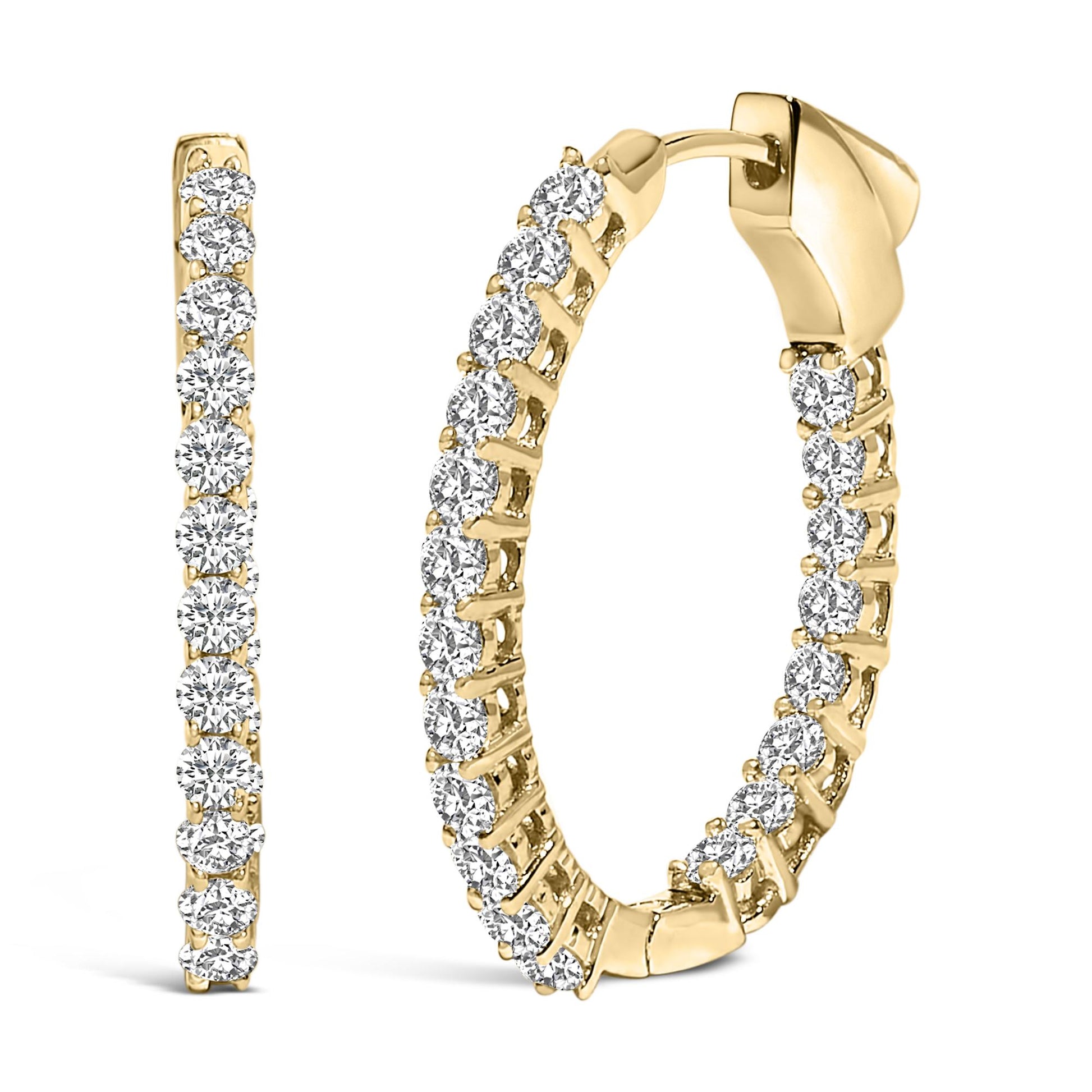 Close-up front and side angle of a pair of yellow metal hoop earrings, each set with multiple round white gemstones in shared prong settings.