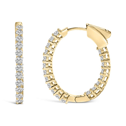 Close-up front and side view of a pair of yellow hoop earrings set with round white gemstones in shared prong settings.