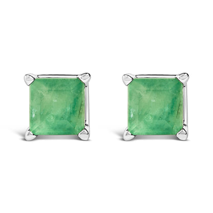 Front-facing shot of a pair of white metal stud earrings, each featuring a square green gemstone in a four-prong setting.