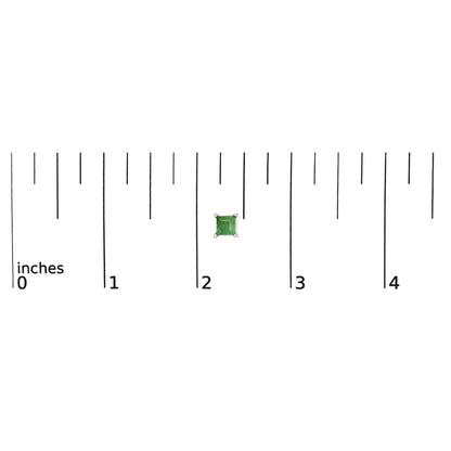 Close-up front view of a white metal stud earring featuring a princess-shaped green gemstone set with four prongs, shown on a scale.