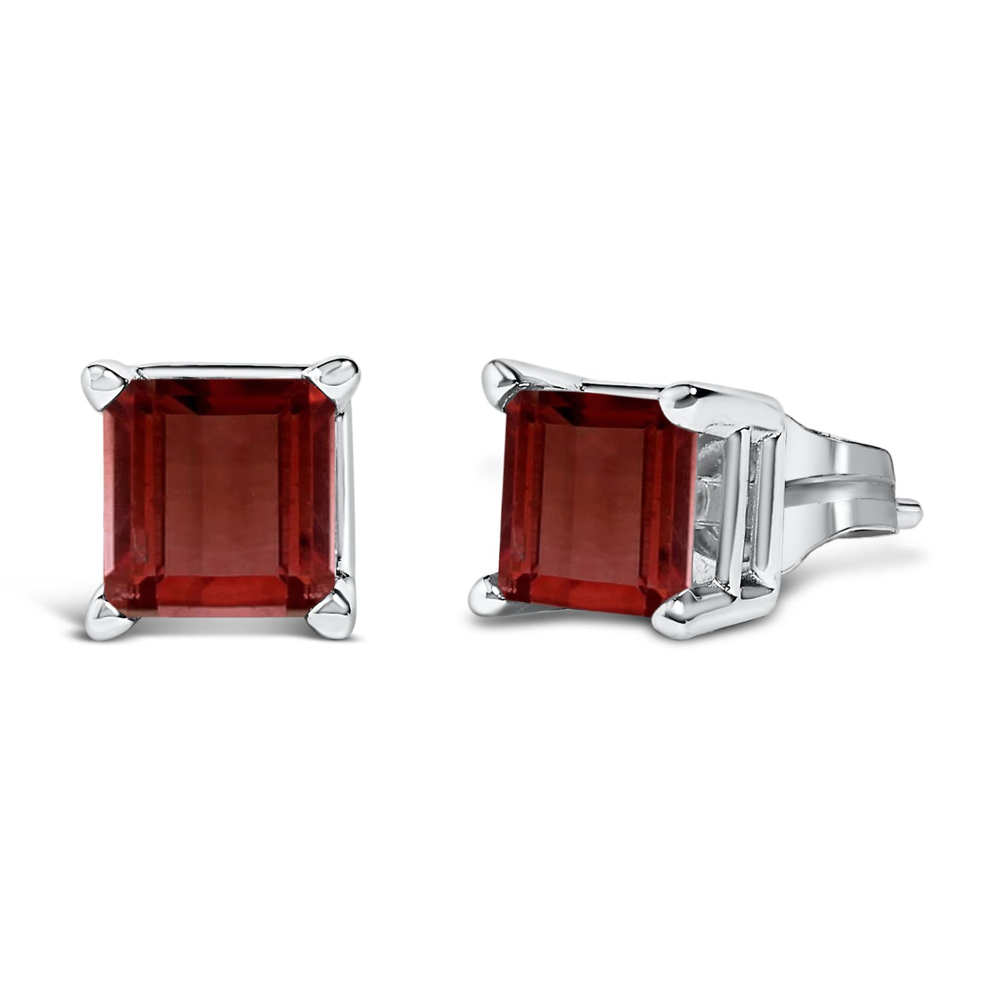 Pair of white metal stud earrings with princess-shaped red gemstones in four-prong settings, shown from front and side angles on a white background.