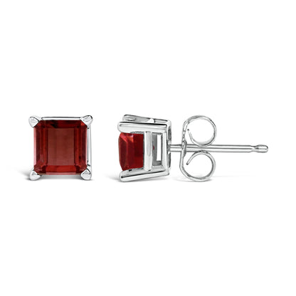 Close-up front and side view of white metal stud earrings featuring square red gemstones in four-prong settings shown on a white background.