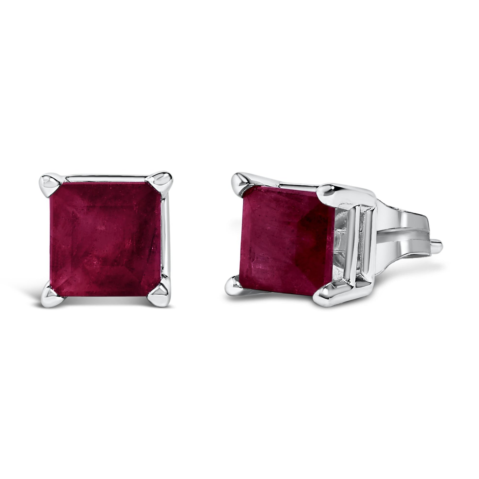 Close-up front and side angle of white metal stud earrings featuring square red gemstones in four-prong settings.