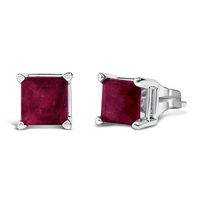 Close-up front and side angle of white metal stud earrings featuring square red gemstones in four-prong settings.