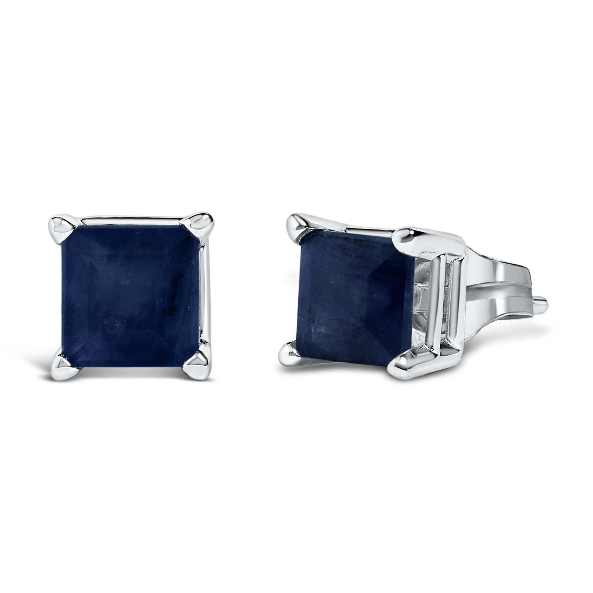 Pair of white metal stud earrings with princess-shaped blue gemstones in four-prong settings, shown at front and side angles on a white background.
