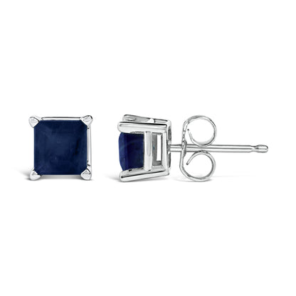 Pair of white metal stud earrings with square blue gemstones in four-prong settings, shown from front and side angles on a white background.