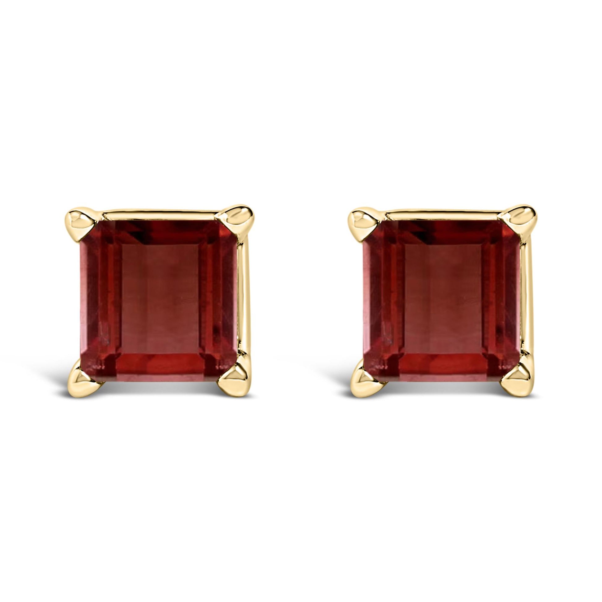 Front view of a pair of yellow metal stud earrings with square red gemstones in four-prong settings on a white background.