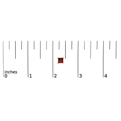 Close-up front view of a single yellow metal princess-shaped red gemstone earring in a 4-prong setting shown on a ruler scale.