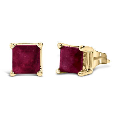 Close-up front and side view of yellow metal stud earrings featuring square-shaped red gemstones in four-prong settings.