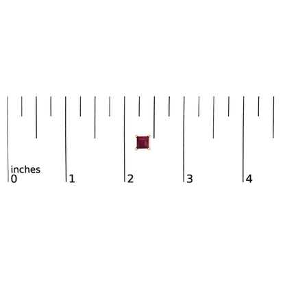 Close-up front view of a single yellow metal stud earring with a princess-shaped red gemstone set in a four-prong setting, shown on a scale.