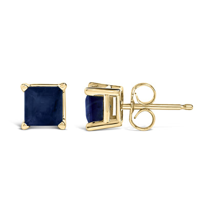 Pair of yellow metal stud earrings with square blue gemstones in four-prong settings, shown from front and side angles on a white background.